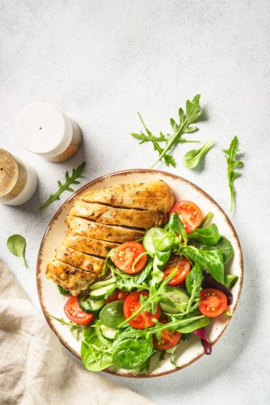 Photo for Green salad with chicken fillet on white. Healthy food. Top view with copy space. - Royalty Free Image