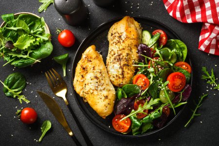 Photo for Fresh salad with chicken fillet and vegetables on black. Healthy food, keto diet. - Royalty Free Image