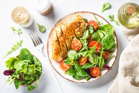 Photo for Healthy food plate on white. Green salad with chicken fillet. Top view with copy space. - Royalty Free Image