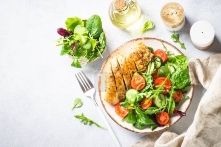 Photo for Healthy food plate on white. Green salad with roasted chicken fillet. Top view with copy space. - Royalty Free Image