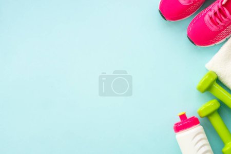 Photo for Dumbbells, sneakers, measuring tape, water bottle and notepad on blue. Healthy lifestile, fitness flat lay. - Royalty Free Image