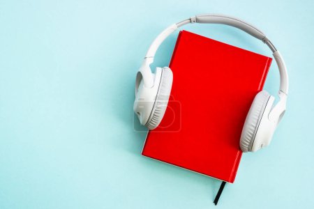 Photo for Audio books concept. Headphones and books on blue background. Listen, study, podcast. - Royalty Free Image