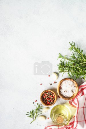 Photo for Ingredients for cooking on white kitchen table. Herbs, spices and vegetables. Top view with space for design, vertical. - Royalty Free Image