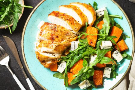 Photo for Healthy salad with baked chicken breast, pumpkin, blue cheese and arugula. Healthy diet food. - Royalty Free Image