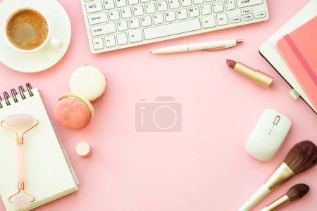 Photo for Home office workspace. Creative Pink flat lay background with keyboard, notebook, coffee cup and cosmetics with space for text. - Royalty Free Image