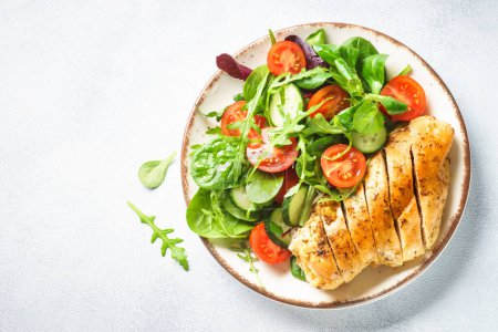 Photo for Healthy food plate. Green salad with chicken fillet on white. Top view with copy space. - Royalty Free Image