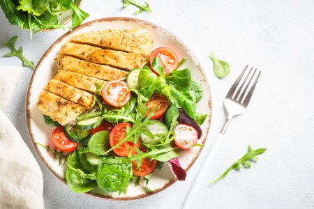 Photo for Healthy food plate on white. Green salad with roasted chicken fillet. Top view with copy space. - Royalty Free Image