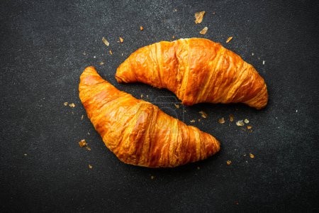 Photo for Croissant at black background. French pastry, bakery, fresh dessrt. Top view. - Royalty Free Image