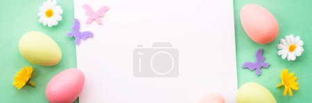 Photo for Easter banner background. Colored Eggs, spring flowers and butterfly. - Royalty Free Image