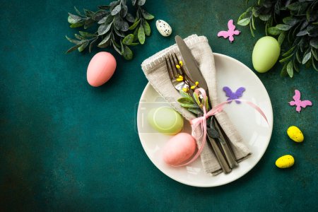 Photo for Easter table setting, Easter food background. White plate with cutlery, eggs, spring flowers and butterfly. Flat lay with copy space. - Royalty Free Image