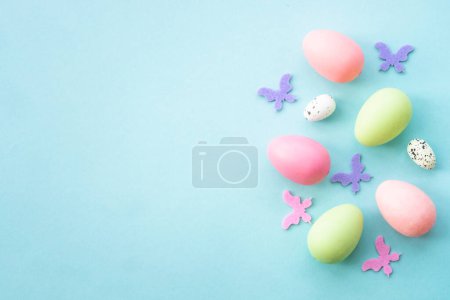 Téléchargez les photos : Oeufs de Pâques, fond de vacances sur bleu. Pose plate avec espace de copie. - en image libre de droit