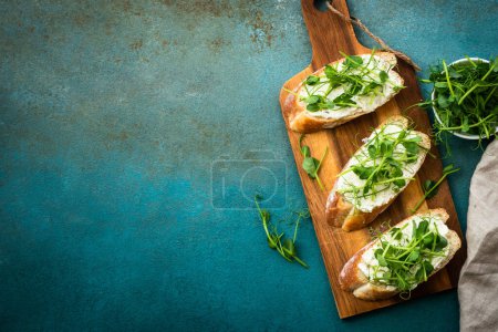 Photo for Toast with micro greens and cheese. Healthy food snack, vegetarian. Top view with copy space. - Royalty Free Image