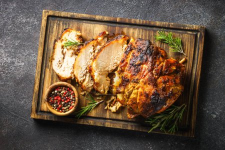 Photo for Roasted pork, baked ham on serving board at black. - Royalty Free Image