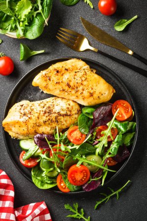 Photo for Fresh salad with chicken fillet and vegetables on black. Healthy food, keto diet. - Royalty Free Image