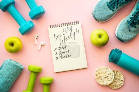 Photo for Healthy lifestyle concept. Fitness equipment and diet food on pink background. Top view. - Royalty Free Image