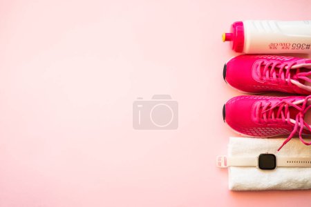 Photo for Workout, healthy lifestyle concept. Sneakers, towel, fitness bbracelet and bottle of water. Flat lay image. - Royalty Free Image