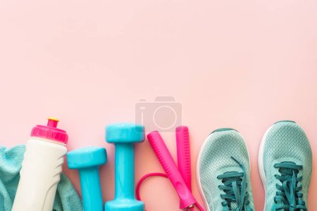 Photo for Fitness background, healthy lifestyle concept. Dumbbells, sneakers, towel and water bottle top view. - Royalty Free Image