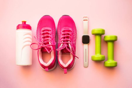 Photo for Workout, healthy lifestyle concept. Sneakers, dumbbells, fitness bbracelet and bottle of water. Flat lay image. - Royalty Free Image
