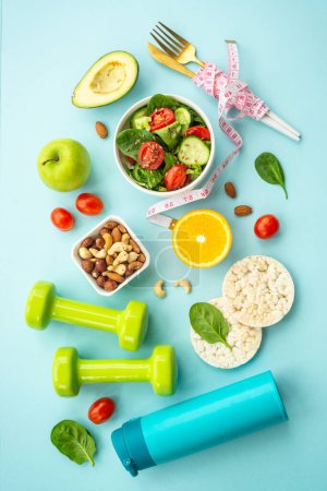 Photo for Diet food, healthy lifestyle and fitness background. Vegan salad, crispbread, fruits and dumbell. Flat lay image. - Royalty Free Image