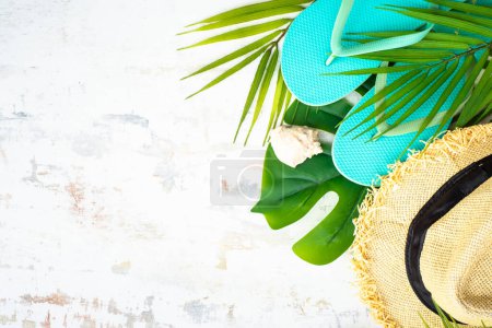 Summer flat lay background, summer holidays and travel concept. Palm leaves, hat, flip flop on white. Poster 654823700