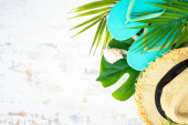 Summer flat lay background, summer holidays and travel concept. Palm leaves, hat, flip flop on white. Poster #654823700