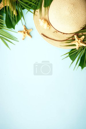 Photo for Summer flat lay background. Summer vacation and travel concept. Palm leaves, sea shells and hat on blue background. - Royalty Free Image