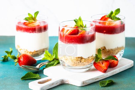 Cheesecake in a glass. Strawberry cheesecake, delicious dessert no baking in jars.