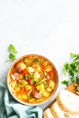 Photo for Minestrone soup, italian vegetable soup with smoked sausages, Top view with copy space. - Royalty Free Image