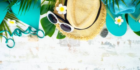 Photo for Summer holidays and travel concept. Palm leaves, hat, flip flop on white. Long banner format. - Royalty Free Image