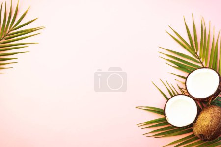 Photo for Summer flat lay background. Palm leaves and coconut on pink background. - Royalty Free Image