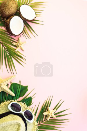 Photo for Summer holidays and travel concept. Palm leaves, sea shells, hat and coconuts on pink background. Flat lay with copy space. - Royalty Free Image