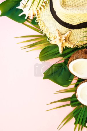 Photo for Summer holidays and travel concept. Palm leaves, sea shells, hat and coconuts on pink background. Flat lay with copy space. - Royalty Free Image
