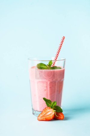 Photo for Strawberry smoothie or milkshake at blue. - Royalty Free Image