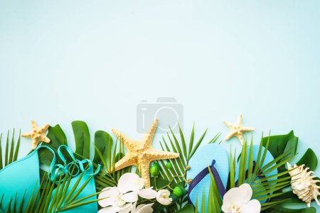 Photo for Summer vacation and travel concept. Palm leaves, hat, flip flop and sunglasses on white background. Flat lay with copy space. - Royalty Free Image