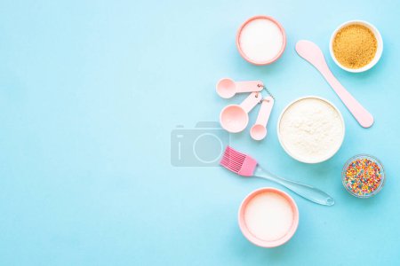 Photo for Food baking background on blue. Ingredients for cooking, flour, sugar, eggs. Flat lay with copy space. - Royalty Free Image