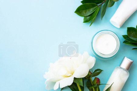 Téléchargez les photos : Natural cosmetic products. Cream, serum, tonic with green leaves and flowers. Skin care concept. - en image libre de droit