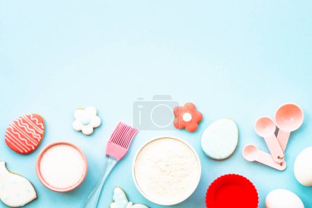 Photo for Easter baking background on blue. Flour, edds, sugar and gingerbread cookies. Top view with copy space. - Royalty Free Image