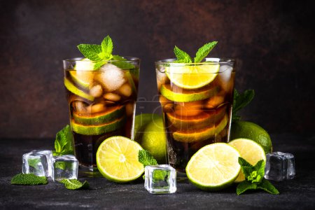 Photo for Cuba Libre alcoholic cocktail, iced drink on dark background. - Royalty Free Image