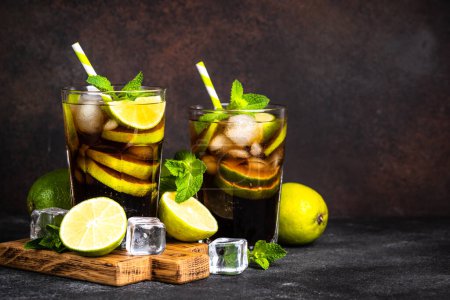 Photo for Cuba Libre, iced alcoholic cocktail on dark background. - Royalty Free Image