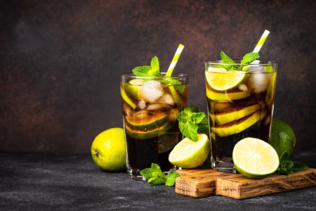 Photo for Cuba Libre alcoholic cocktail, iced drink on dark background. - Royalty Free Image