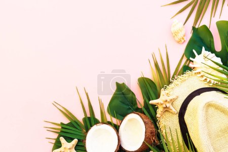 Photo for Summer flat lay background. Tropical leaves, coconut, hat and sea shells on pink background. - Royalty Free Image