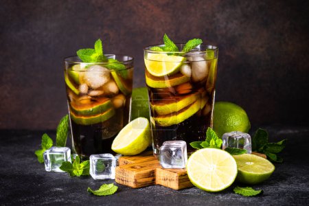 Photo for Cuba Libre, iced alcoholic cocktail on dark background. - Royalty Free Image