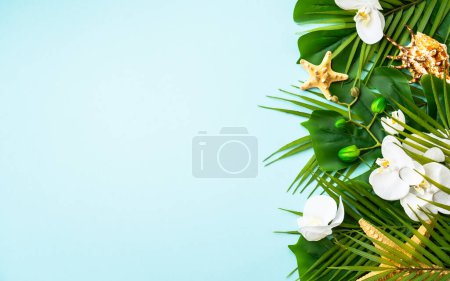Photo for Summer flat lay on blue background. Tropical leaves, flowers and sea shells. - Royalty Free Image