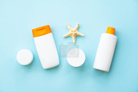 Photo for Sun screen skin care products on blue. Sun protection for summer holidays, beach relax and sunbathing. Flat lay. - Royalty Free Image