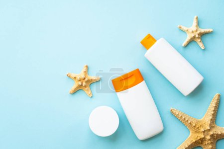 Photo for Sun screen products on blue background. Sun protection for summer holidays, beach relax and sunbathing. Flat lay. - Royalty Free Image