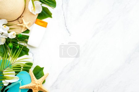 Photo for Summer vacation and travel concept. Palm leaves, sun screen, hat and flip flop on white background. Flat lay with copy space. - Royalty Free Image