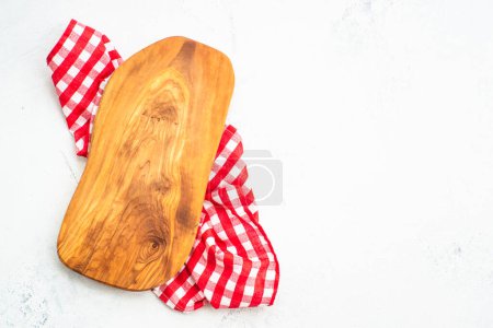 Photo for Olive board and tablecloth on white kitchen table. Cutting board, kitchen utensils, food background. - Royalty Free Image