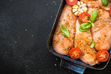 Photo for Chicken fillet, raw chicken meat breast with spices and vegetables in the pan. Top view, ready for cooking in the oven. - Royalty Free Image
