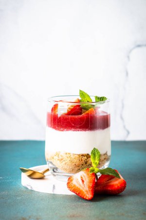 Photo for Cheesecake in a glass. Strawberry cheesecake, delicious dessert no baking with fresh berries. - Royalty Free Image