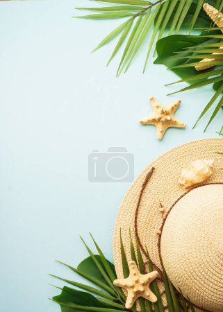Photo for Summer flat lay background. Summer vacation and travel concept. Palm leaves, hat, sea shells and flowers on blue background. - Royalty Free Image